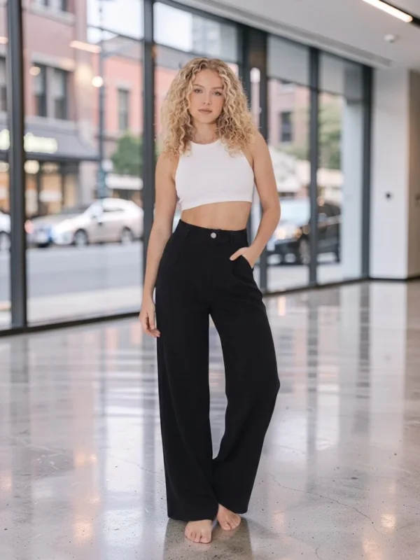 Pantalon large extensible noir porté avec haut blanc